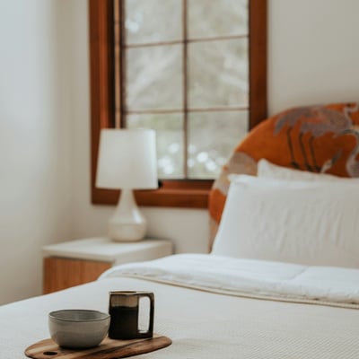 This cozy bedroom features natural light, a warm atmosphere, and thoughtful decor for relaxing retreats.