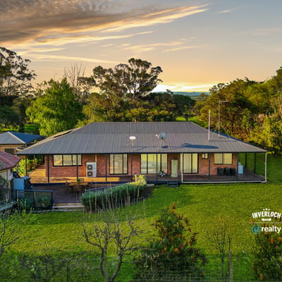 Spacious home set on lush grounds, featuring expansive outdoor areas and stunning views of the landscape.