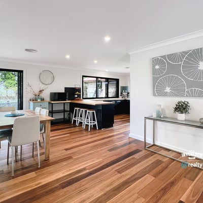 Spacious open-plan living area with modern finishes, large windows, and abundant natural light throughout.