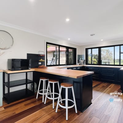 Bright and functional kitchen featuring modern appliances, ample counter space, and scenic views through expansive windows.