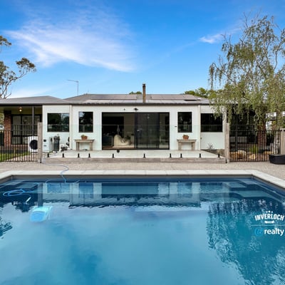Contemporary home featuring a spacious poolside area, ideal for outdoor entertaining and relaxation.
