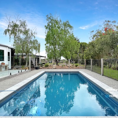 This property features a refreshing pool and landscaped yard, perfect for outdoor gatherings and relaxation.