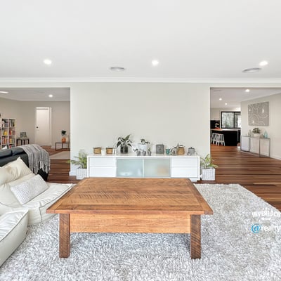 Spacious living area with modern design, featuring abundant light and seamless flow to adjacent rooms.