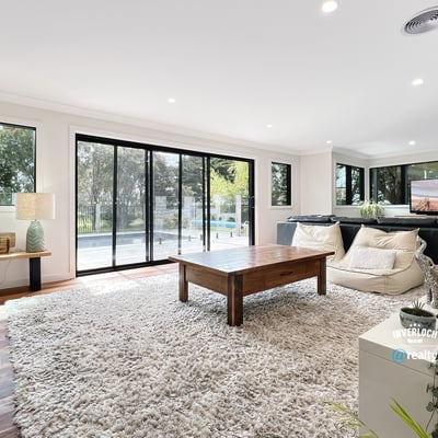 Spacious living area featuring large windows, modern furnishings, and seamless indoor-outdoor flow for relaxation and entertainment.