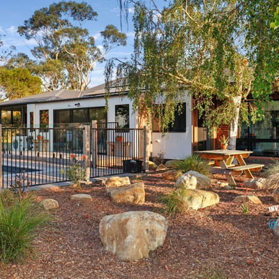 This inviting home features a spacious outdoor area with landscaped gardens and a relaxing poolside retreat.