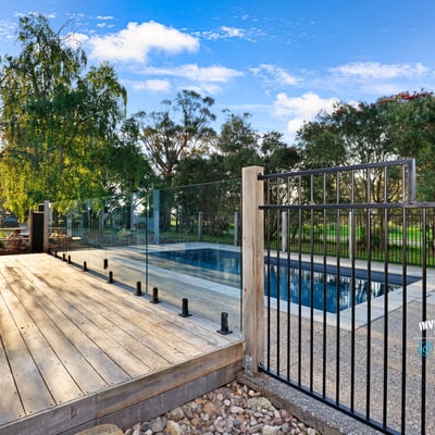 Discover a modern outdoor retreat featuring a pristine pool and expansive nature views, perfect for relaxation.