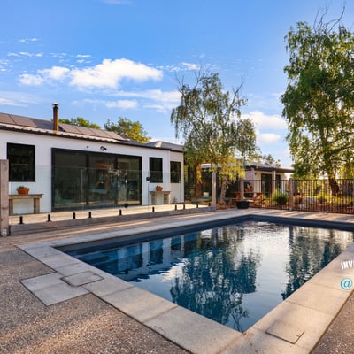 Discover a modern home featuring an inviting outdoor pool and spacious patio, perfect for entertaining.