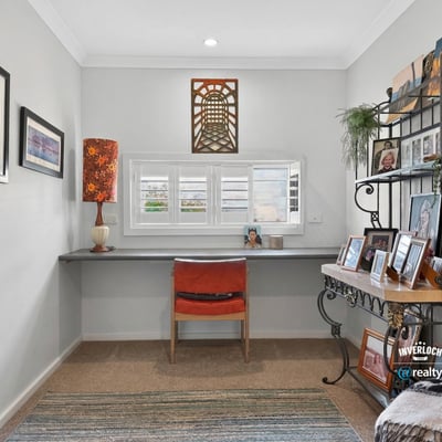 Bright and airy workspace featuring a modern desk, natural light, and personalized decor for inspiration.