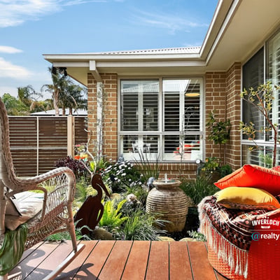 Discover a cozy outdoor space featuring lush landscaping, perfect for relaxation and outdoor gatherings.