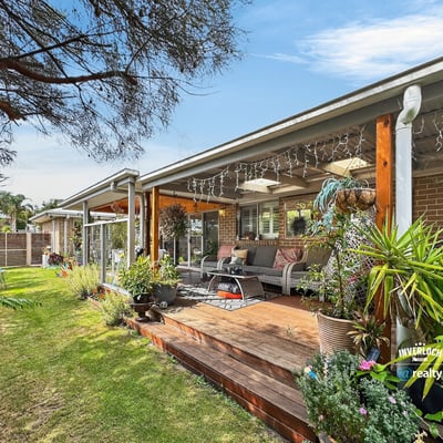Spacious outdoor living area surrounded by lush landscaping, perfect for relaxation and entertaining.