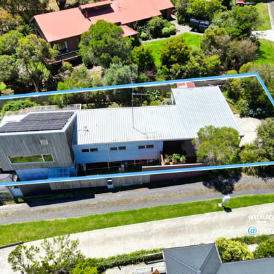 Modern home featuring spacious outdoor areas, situated on a beautifully landscaped lot with ample privacy.