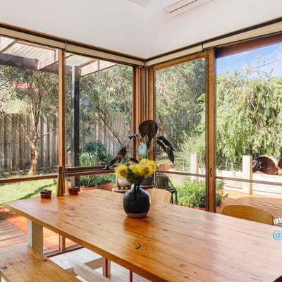 Bright indoor-outdoor living space featuring abundant natural light and a peaceful garden view.