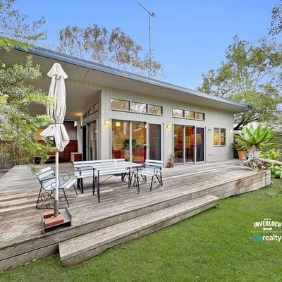 Bright, open-concept home featuring expansive outdoor living space and lush landscaping, ideal for entertaining.
