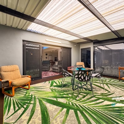 Spacious outdoor patio perfect for gatherings, featuring comfortable seating and vibrant tropical decor.