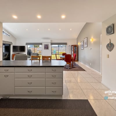 Spacious kitchen and living area with ample natural light, perfect for comfortable family gatherings and entertaining.