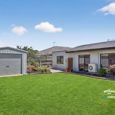 Discover this inviting home with a spacious lawn and a convenient shed, perfect for outdoor activities.