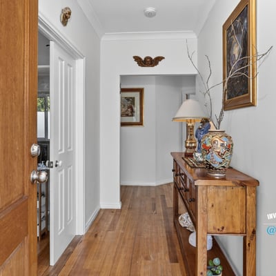 Welcoming entryway featuring warm wooden accents, unique decor, and a cozy atmosphere for guests.