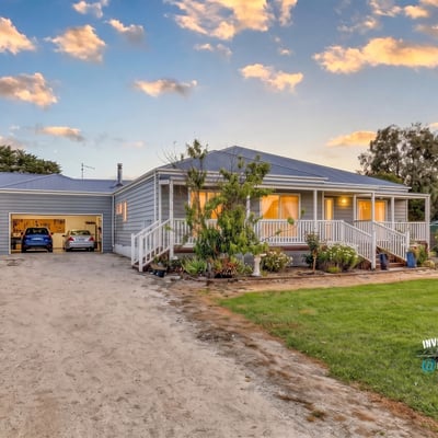 This inviting home features spacious gardens, ample parking, and a welcoming front porch in a peaceful setting.