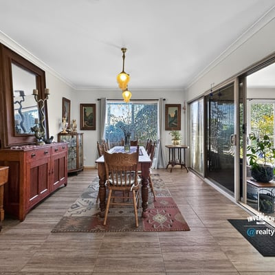 Spacious dining area featuring natural light, attractive décor, and easy access to a vibrant outdoor space.