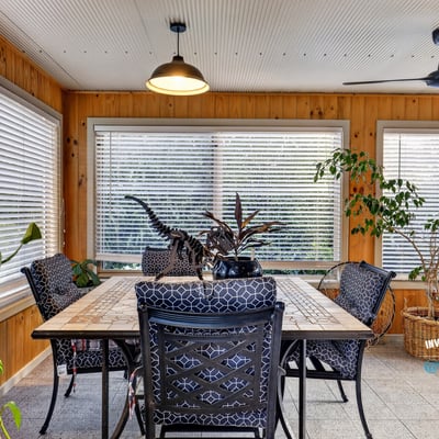 Bright and airy sunroom featuring ample natural light, perfect for relaxation or casual dining.