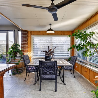 Bright and airy sunroom features large windows, perfect for enjoying peaceful views and entertaining guests.
