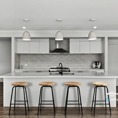 This contemporary kitchen features a spacious island and modern appliances, perfect for culinary enthusiasts.