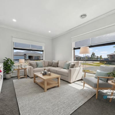 Bright and inviting living room featuring large windows, modern furnishings, and a spacious layout for relaxation.