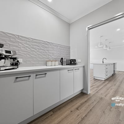 Modern kitchen featuring sleek cabinetry and ample space, perfect for culinary enthusiasts and entertaining guests.