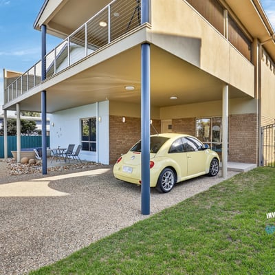 Spacious multi-level home featuring outdoor parking, a covered patio, and a lush backyard for relaxation.