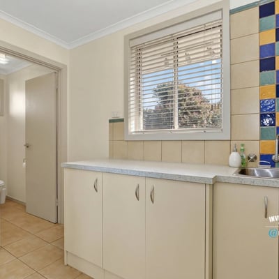 Bright and functional kitchen space featuring colorful backsplash tiles and ample storage options.
