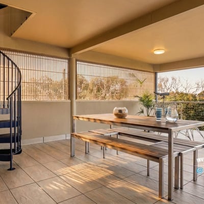 Spacious outdoor terrace featuring a spiral staircase, perfect for entertaining and enjoying panoramic views.