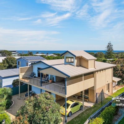 Experience coastal living in this spacious home with stunning ocean views and ample outdoor space.
