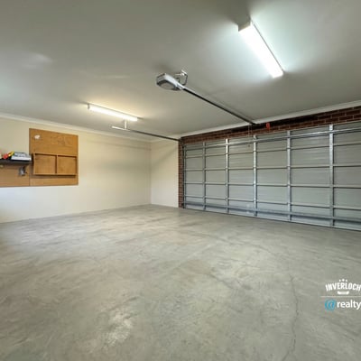 Spacious garage featuring ample storage options and abundant natural light, ideal for vehicles and projects.