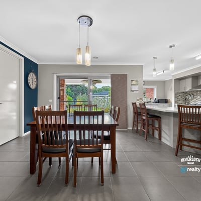 Modern kitchen and dining area with ample natural light and direct access to an outdoor space.
