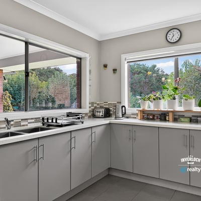 Modern kitchen featuring spacious countertops and abundant natural light, ideal for culinary enthusiasts and gatherings.