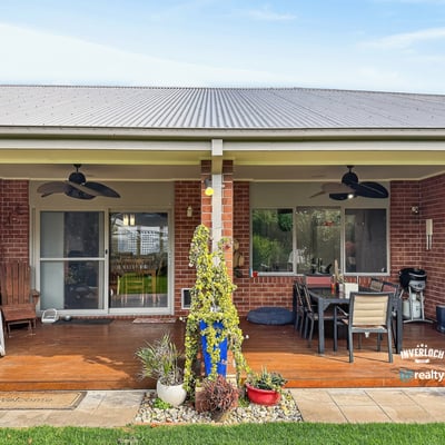 Spacious outdoor area with a covered patio, perfect for entertaining and enjoying the serene backyard.
