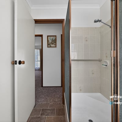 This bathroom features a convenient layout with practical finishes just steps from the living area.