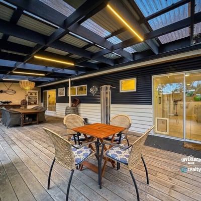 Inviting outdoor space featuring a covered patio and ample seating for leisure and entertainment.