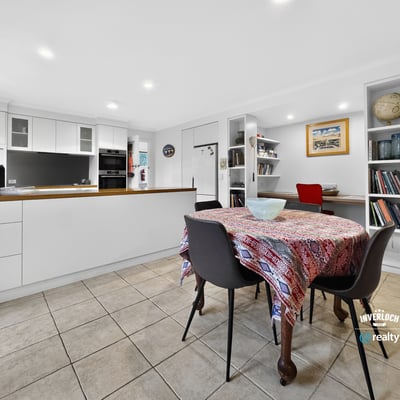 Bright and inviting kitchen and dining area, featuring modern finishes and ample storage space.