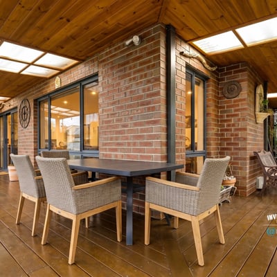 Spacious outdoor patio with dining area and built-in grill, perfect for entertaining and enjoying gatherings.