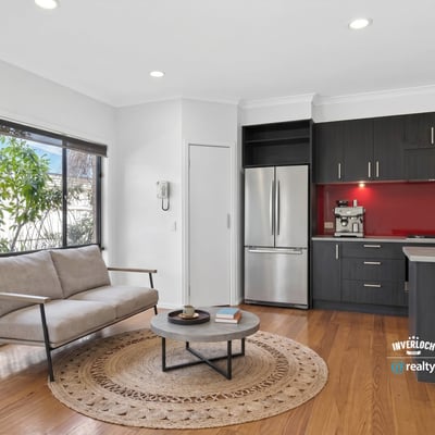 Modern kitchen and inviting living area with natural light, perfect for comfortable daily living.