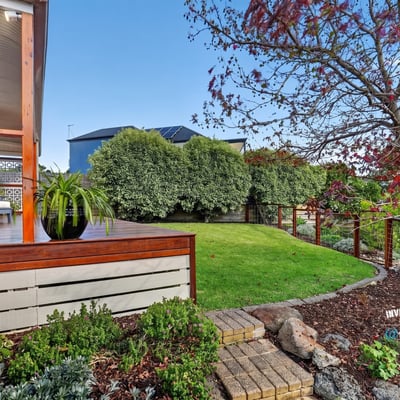 Inviting outdoor space with landscaped garden and seating area, perfect for relaxation and entertaining.