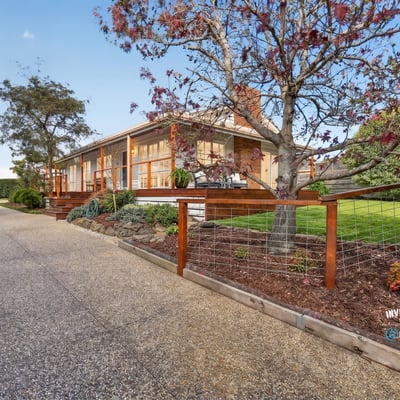 This welcoming home features spacious outdoor areas and a scenic driveway, perfect for family gatherings and relaxation.