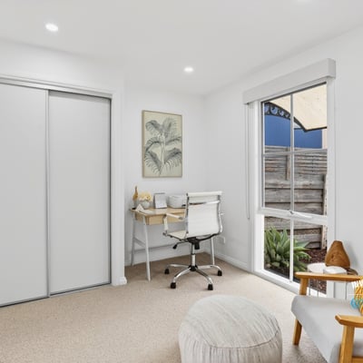 Bright and functional office space featuring natural light, modern furnishings, and streamlined storage solutions for productivity.
