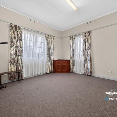 Spacious room featuring large windows, abundant natural light, and versatile flooring for various designs.