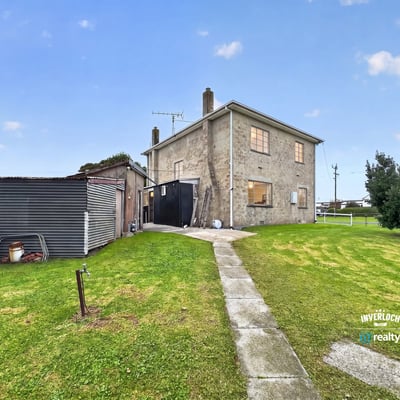 Spacious two-story home with a large yard, ideal for customization and outdoor activities.