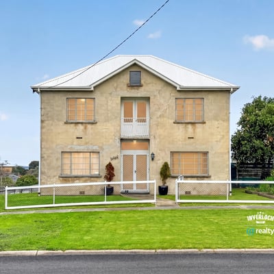 Spacious two-story home with ample yard space, perfect for customization and outdoor living.