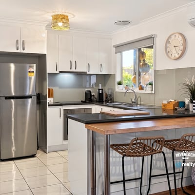 Modern kitchen featuring sleek cabinetry, stainless steel appliances, and a spacious breakfast bar perfect for entertaining.
