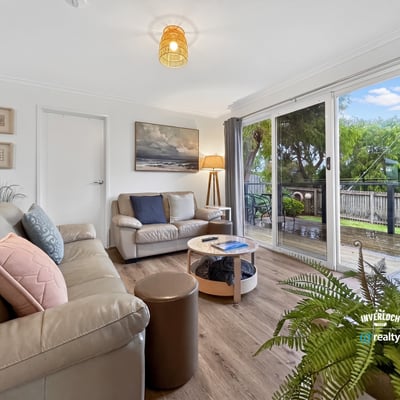 Bright living space featuring large windows that overlook a picturesque outdoor area, perfect for relaxation.