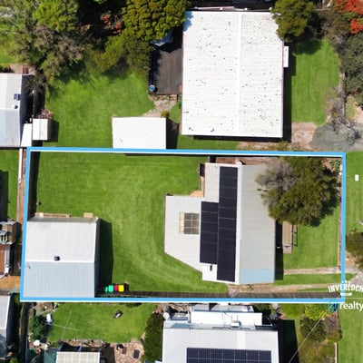 Spacious lot with ample outdoor space, featuring a well-maintained home and multiple storage options close to amenities.